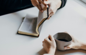 Christian tutor using Bible verses to support a child’s learning, integrating faith and academics in a homeschooling session.