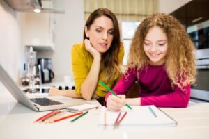 a mother helping her daughter with schoolwork